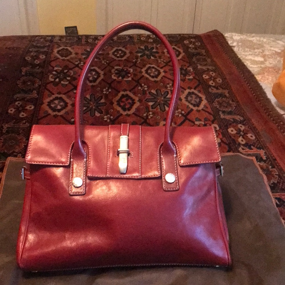 Michael Kors Burgandy handbag in mint condition.  Non smoking house.